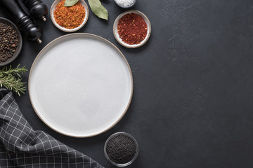 Gray platter and spices for cooking and marinade. Space for text. View from above.