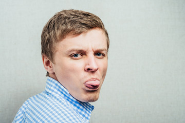 man shows tongue