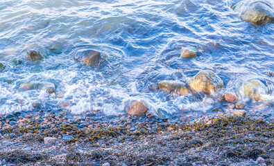 sea shore with stones and waves