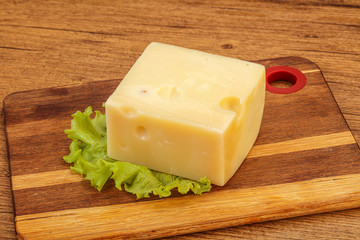 Emmental cheese over wooden board