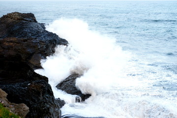 The ocean is breaking on the rocks