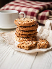 Fototapeta na wymiar Oatmeal cookies. Oatmeal cookies and a cup of coffee on the table. Breakfast.