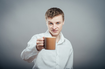 young man offers a cup of tea