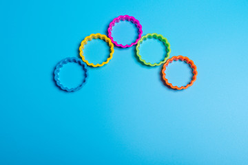 Five multi-colored plastic cookie cutter for making cookies on a blue background. Culinary concept....
