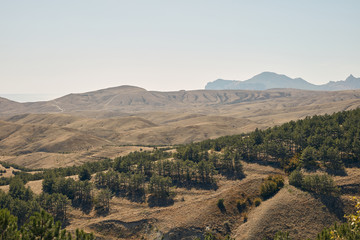 green hills against the background of mountains