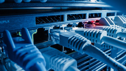 Close-up Macro Shot: Ethernet Cables Connected to Router Ports. Telecommunications: RJ45 Device...