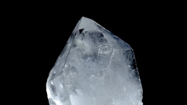 Healing crystal stone macro mineral, white rough quartz crystals on black background. Mystery jewelry from nature. rotation crystal