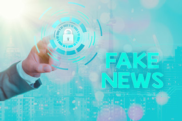 Writing note showing Fake News. Business concept for false information publish under the guise of...