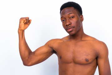 Young handsome African man shirtless against white background