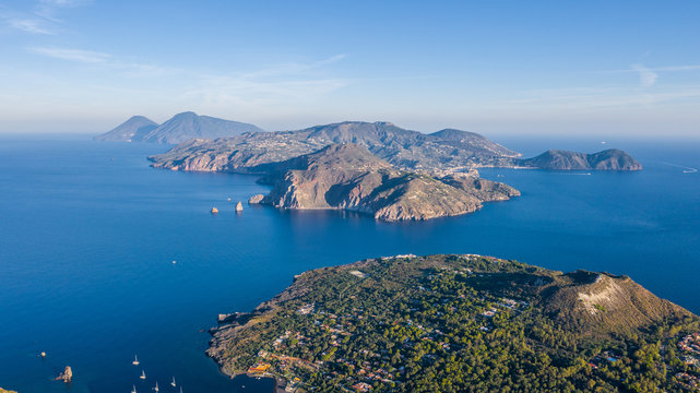 Beautiful panoramic aerial view photo from flying drone on Vulcano Island to Lipari and Salina Island of the Aelian Islands, Italy on a summer with blue sky (series)