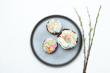 Easter cakes on a gray plate. Religious holiday. Place under the text. Easter banner. Frosting on the sandwich.