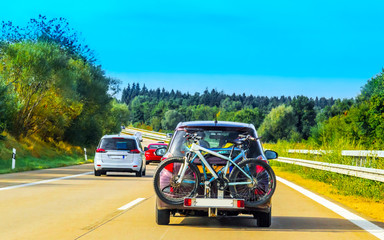 Fototapeta na wymiar Car with bicycles in highway in Switzerland reflex