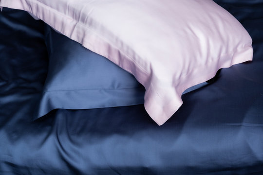 Pillows in blue and pink silk. Silk pillowcases. Satin bedding.