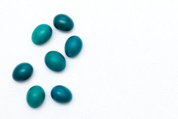 Emerald Easter eggs on a light background. Easter banner. Religious holiday. Chicken colored eggs. Easter banner with place for text.