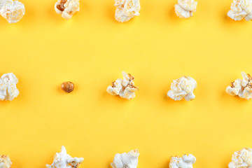 Obraz na płótnie Canvas Caramel popcorn isolated on a yellow background, scattered. Mockup, frame of popcorn, top view.