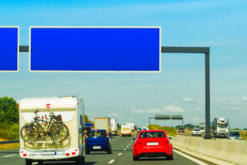 Caravan with bicycles and cars on road in Switzerland reflex