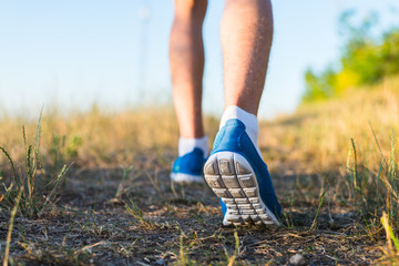 Athlete running in the sand feet