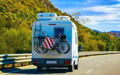 Rv cavaran with bicycles on road in Sardinia reflex