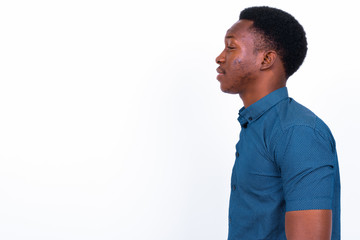 Young handsome African man against white background