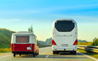 Camper and bus on road in Switzerland reflex