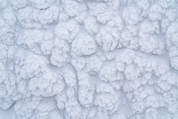 Icy texture of snow after a blizzard on a windy morning.