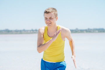 Athletic young male running on the beach