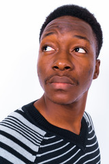 Obraz premium Young handsome African man against white background