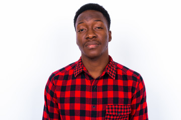 Young handsome African man against white background