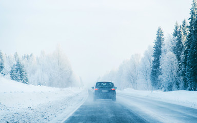 Car in a road a snowy winter Lapland reflex