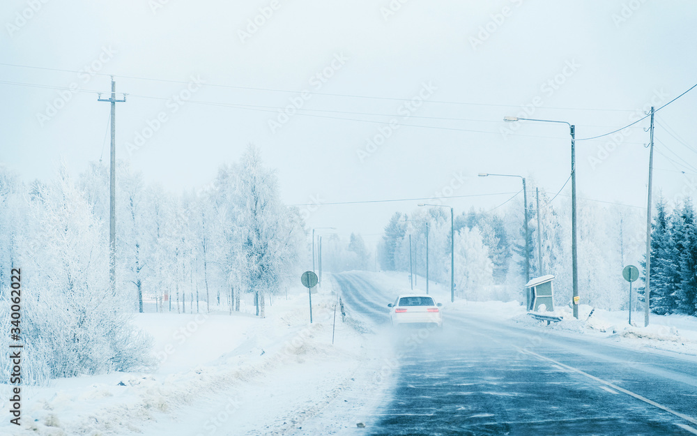 Poster Car on a road at a snowy winter Lapland reflex