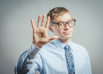 young man in glasses waving, smiling