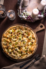 Pizza with various cheese, walnuts and grapes