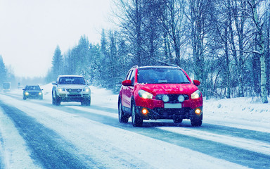 Car with head lamp on road in winter Rovaniemi reflex