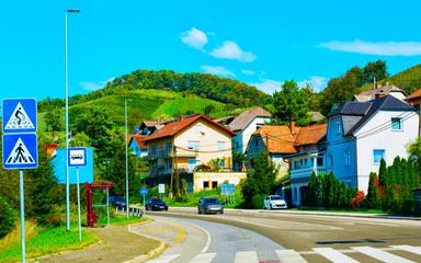 Pedestrian crossing and Residential houses along road in street Maribor reflex
