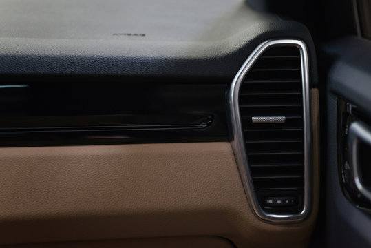 Modern car dashboard detail. Airbag panel and air conditioning hole.