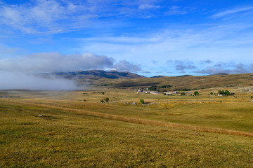 Obraz premium Clouds creep on the ground. Panoramic road in National Park Durmitor, Montenegro.