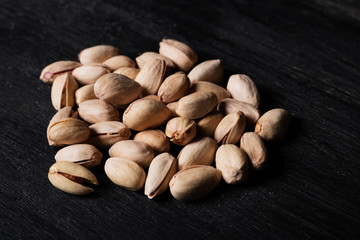 pistachio nuts on wooden table