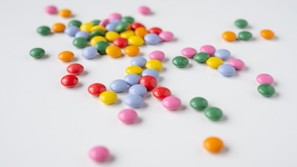 colorful medication and candies on white background