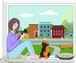 Vector illustration of a girl staying home, isolating, sitting at a window looking at her tablet, beside her is a cat looking out at the street empty of people because of covid 19 lockdown.  