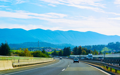 Scenic landscape with cars at road in Slovenia Julian Alps reflex
