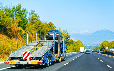 Car carrier truck on road reflex