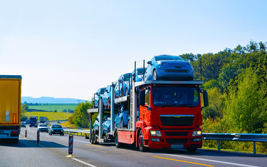 Fototapeta premium Cars carrier truck asphalt road Poland reflex