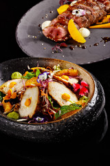 Delicious salad and medium well done steak dish in fine dine in restaurant. Presentable appetizer and main course dish photography nice food plating perfect for magazine concept.
