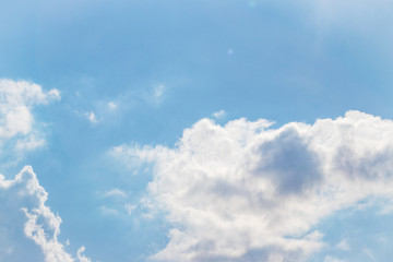 Blue sky with white fluffy clouds background