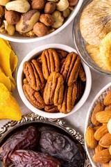 Pecan, assorted nuts and dried fruits, top view, close up, vertical format