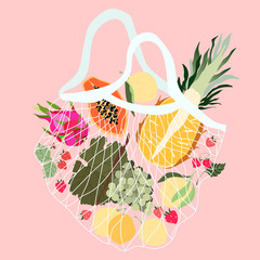 Fruits in a mesh bag. Variety of fresh tropical fruits in a reusable ECO bag. Pineapple, grapes, dragonfruit, lemons, and strawberries from local grocery shops. Healthy food delivery.