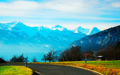 Fototapeta na wymiar Road at Sigrilwil village Swiss Alps mountains Thun lake reflex