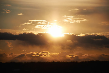 Orange bright Sunny sunset in the sky with clouds. Landscapes nature