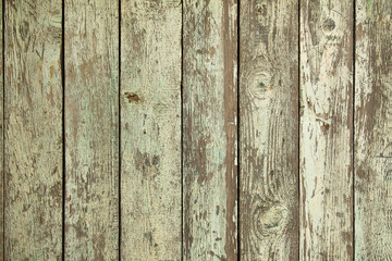 The texture of vintage wooden boards, grunge. Background of vertical planks, closeup.