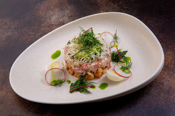 Salad of chicken fillet cooked in its own juice, home-made boiled pork, boiled beef tongue, sausage and cheese. European cuisine. The work of a professional chef. Dish from a restaurant or cafe menu